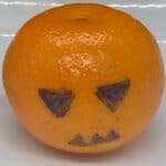 clementine-with-jack-o-lantern-face-drawn-in-black-marker