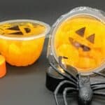 mandarin-segments-in-snack-pot-with-jack-o-lantern-face-drawn-on-lid