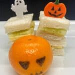 dairy-free-cheese-cucumber-sandwich-stack-pumpkin-face-topper-and-jack-o-lantern-clementine-pen-drawn-face